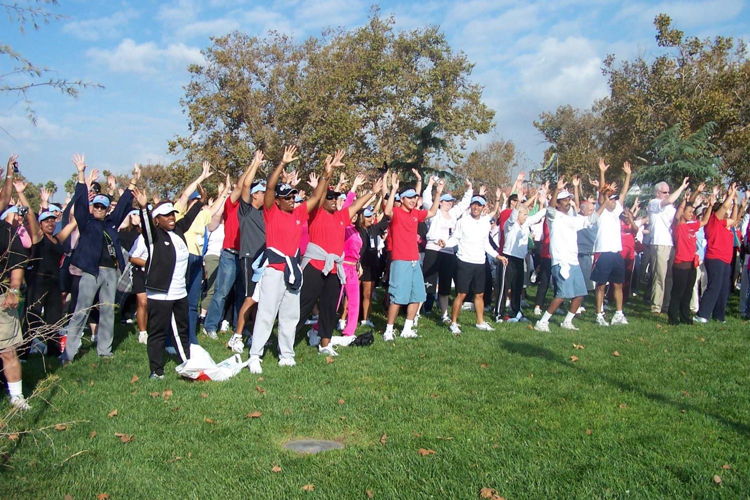 The crowd warms up before heading out to complete the three-mile walk.