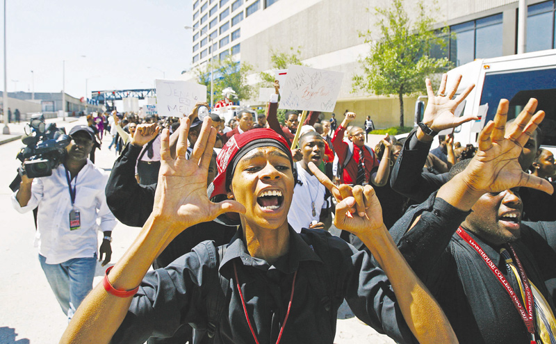 A+protester+flashes+the+number+six+to+represent+the+Jena+6+students