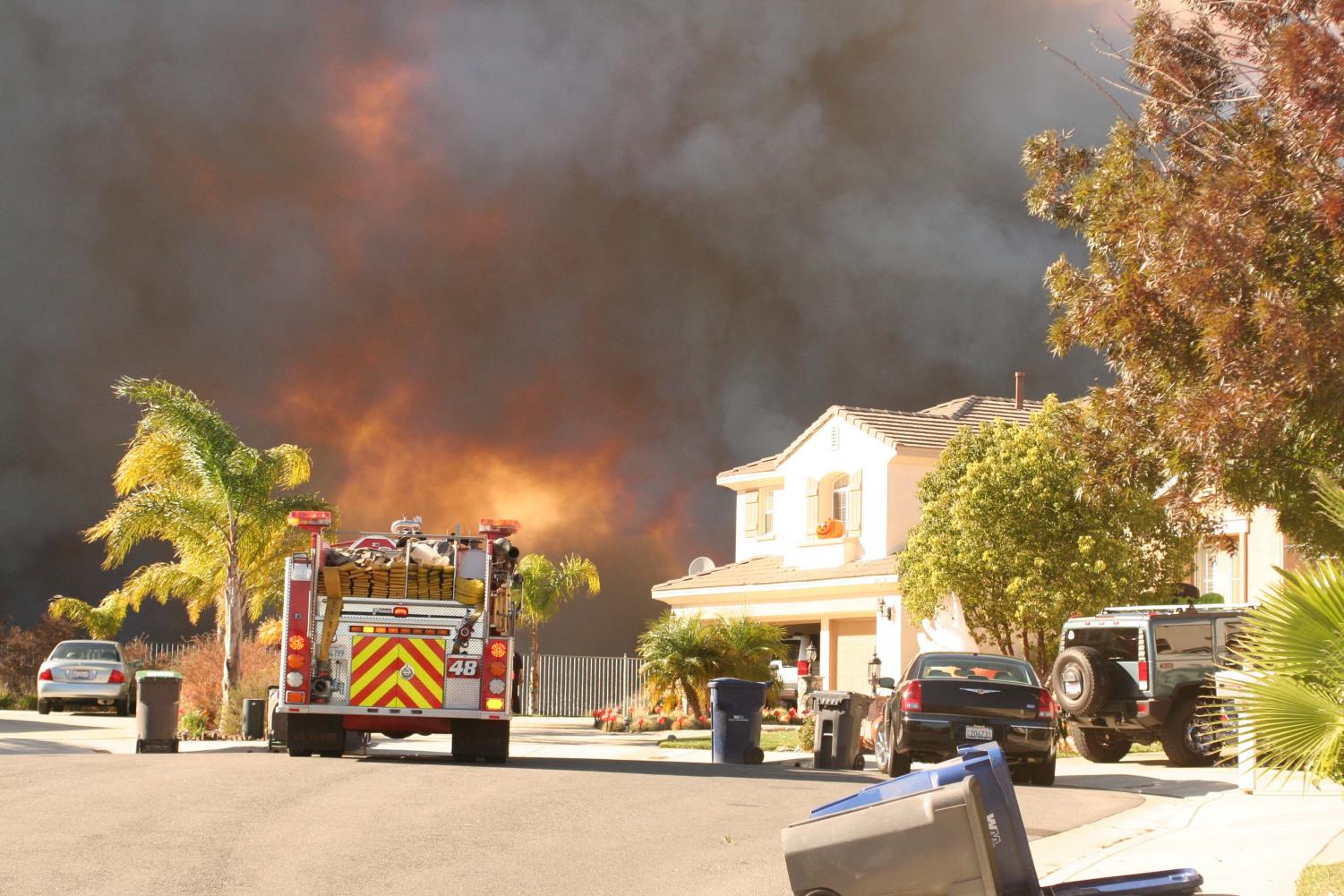 A fire truck sits in the Stevenson Ranch residential area during the Magic Moutnain fire Tuesday afternoon.