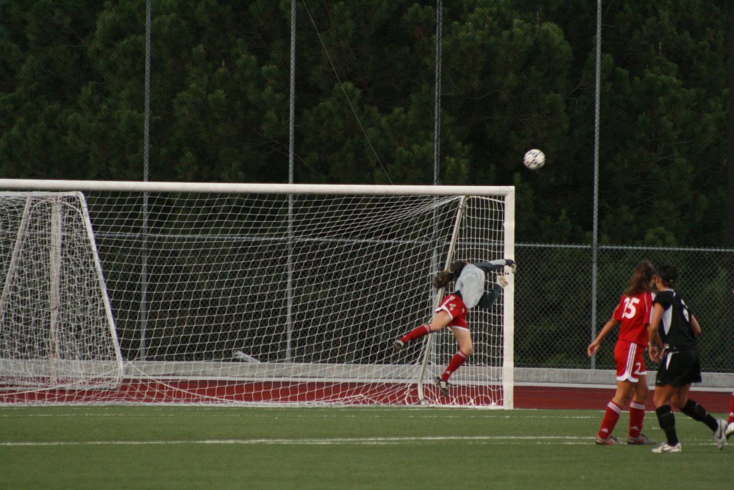 Biola goalkeeper Lauren Gregston jumps and saves the team from being scored on. Gregston made 11 saves over the course of the APU game on Saturday.