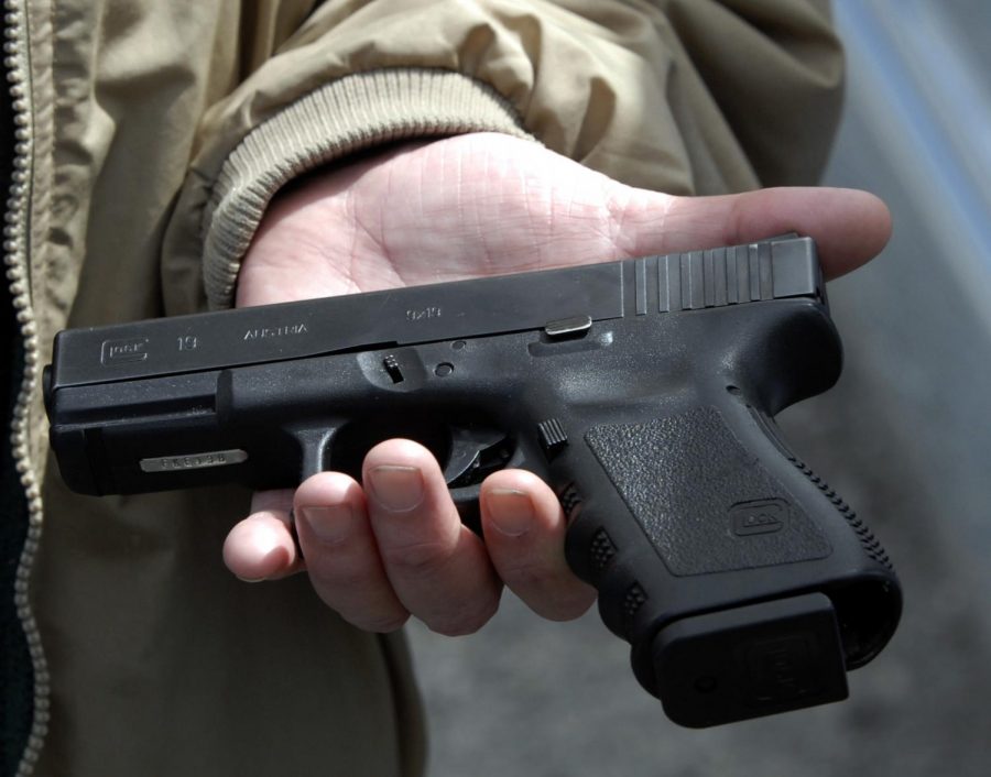 Firearms owner John Markell holds a Glock 9 mm pistol in Roanoke, Va., in this April file photo. The gun is similar to one sold to Seung-Hui Cho, the Virginia Tech shooter. Congress on Wednesday passed a long-stalled bill inspired by the Virginia Tech shootings that would more easily flag prospective gun buyers who have documented mental health problems. (AP Photo)