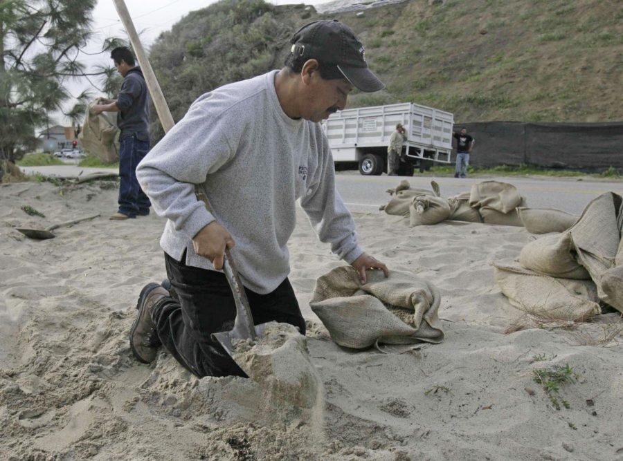 Francisco Alvarado fills sand bags Thursday, Jan. 3, 2008, in Malibu, Calif., as residents prepare for potential mudslides in previously burned areas.