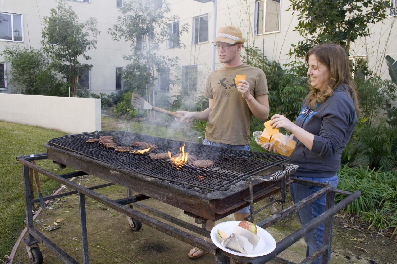During the brother-sister barbeque friday afternoon outside Horton Hall, juniors Kevin Scholl and Stephanie Gaskins worked at the grill preparing the lunch. Hosting brother-sister floor events is just one of many duties performed by RAs.