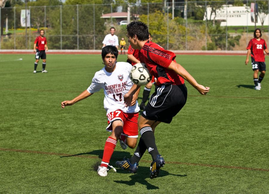 Brandon Gonzalez, a senior, receives a throw-in from teammate Alex Honore. Photo by Mike Villa