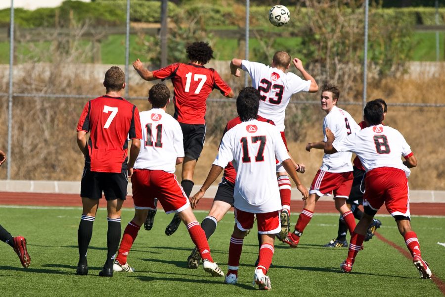 Alex Honore and an opponent go head-to-head in an effort to control a high-kicked ball. Photo by Mike Villa