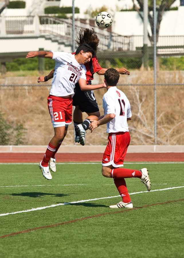 Zach Bautista shows off his hops while out-jumping an AACA forward. Photo by Mike Villa