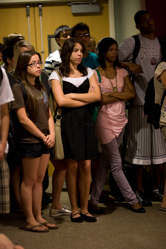 Freshman Samantha Aviles and a small crowd of other students found a few empty spaces at the back of the banquet room, which was entirely filled for the poetry night. Photo by Mike Villa