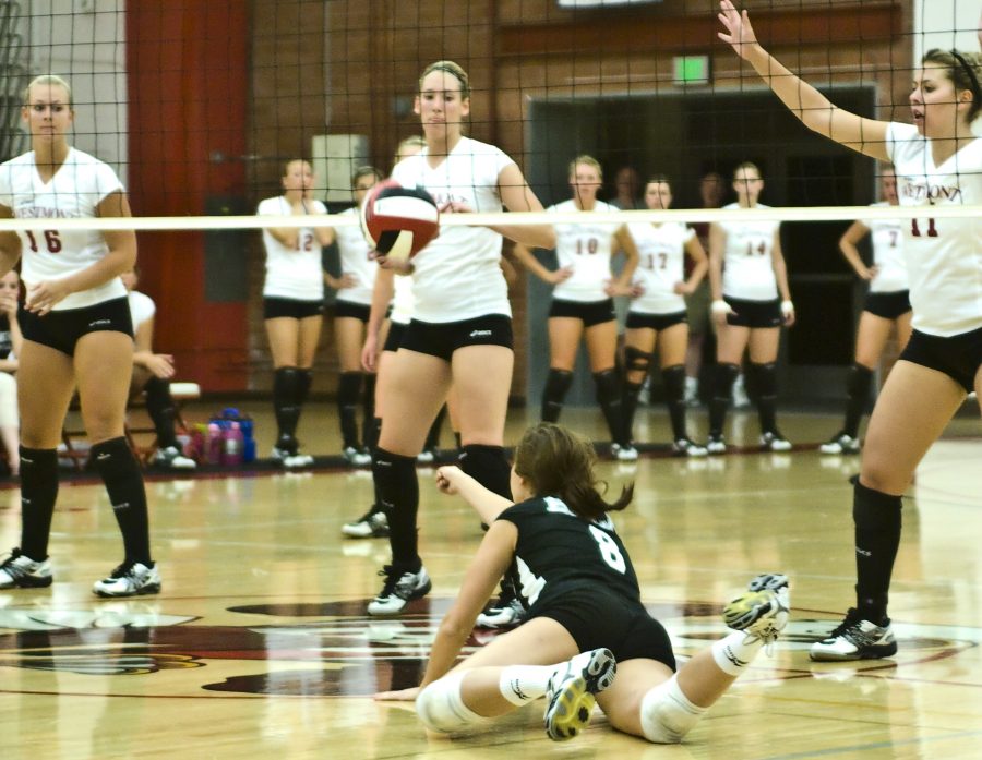 Freshman outside hitter, Kim Russell slides for a dig off of a block in Biolas game against Westmont Saturday night in Chase Gymnasium, which they won in a 25-7, 25-18, 25-22 sweep. Photo by Christina Schantz