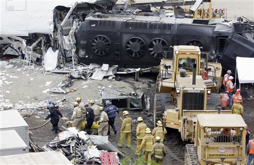 Emergency responders remove a body from the Metrolink commuter train that collided with a Union Pacific freight train Friday in Chatsworth, Calif., Saturday, Sept. 13, 2008  Photo by AP Photo/ Rene Macura