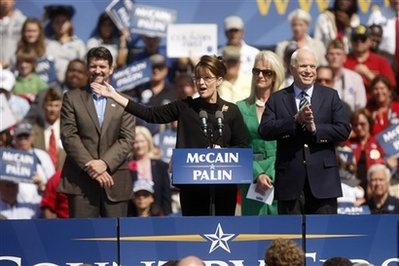 Republican vice presidential candidate, Alaska Gov. Sarah Palin, second from left, accompanied by her husband Todd, left, Republican presidential candidate Sen. John McCain, R-Ariz., right, and his wife Cindy, gestures while addressing a rally, Wednesday, Sept. 10, 2008, in Fairfax, Va. Photo by AP Photo/Gerald Herbert)