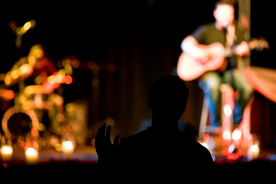 An audience member connecting with the worshipful music played by Shane and Shane as the concert became a time of praise in addition to an entertaining concert.   Photo by Mike Villa