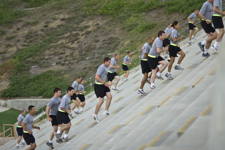 ROTC students enduring their Wednesday morning physical training on up and down the stadium stairs.   Photo by Kelsey Heng