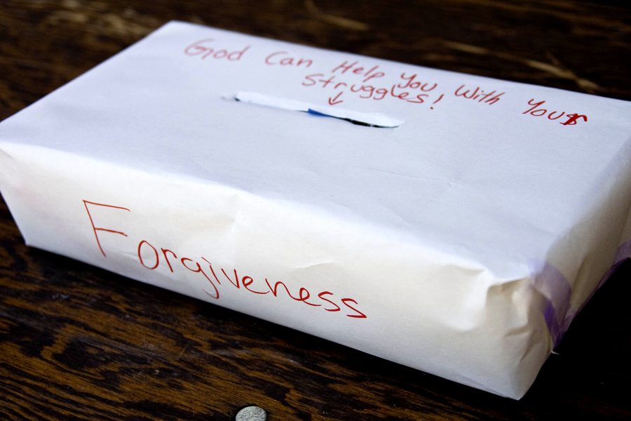 Boxes and slips of paper were placed around campus on Oct. 8 for students to submit to God sins of repentance that were all thrown into a fire later that night at After Dark on McNally field.   Photo by Kelsey Heng