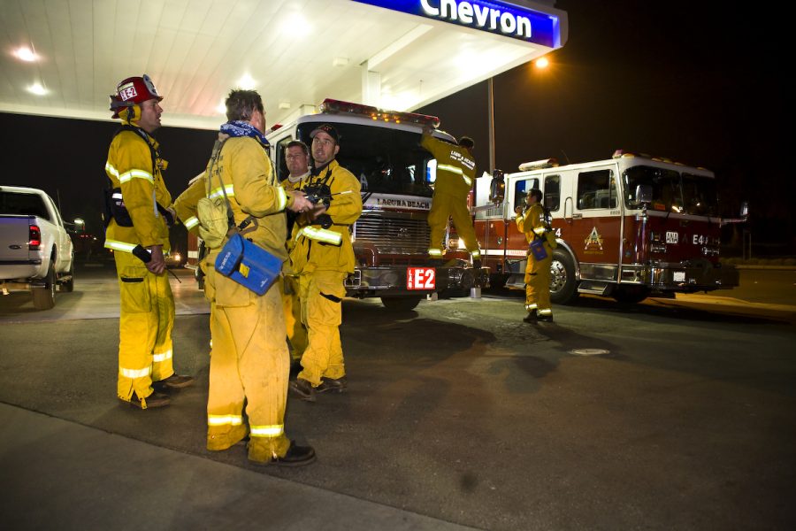 Fire brigades from all over Orange County including Newport, Laguna Beach, Orange City, and Brea, reorganize at a Chevron on Imperial. Photo by Mike Villa