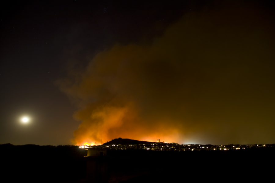 The Freeway Fire crests the Carbon Canyon Park ridge and begins overtaking an evacuated neighborhood. Photo by Mike Villa