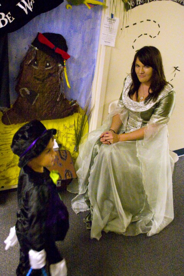 Vivace Kendall Robins, Freshman, sits by her door while handing out candy. Her dorm room door won 3rd place in the decorating competition.  Photo by Christina Schantz