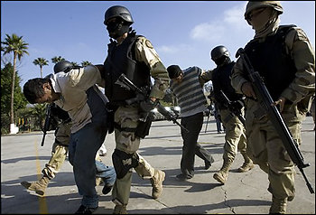 Mexican Army soldiers hold two suspects, arrested during an operation against drug smuggling and kidnapping gangs, after being presented to the press in Tijuana, Mexico, Wednesday, Dec. 3, 2008.  Photo by AP Photo/Guillermo Arias