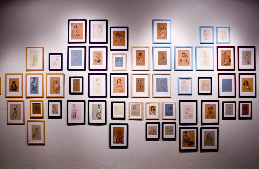 Jessica Jorgenson filled one wall in the art gallery with her charcoal drawings of Biola students.  Photo by Bethany Cissel