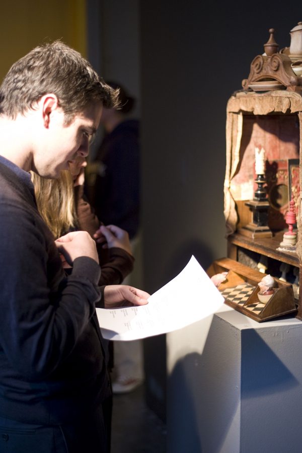 Alumnus Tim Bartel looks at one of the pieces on display in of Barry Krammes show, Morality. Photo by Mike Villa
