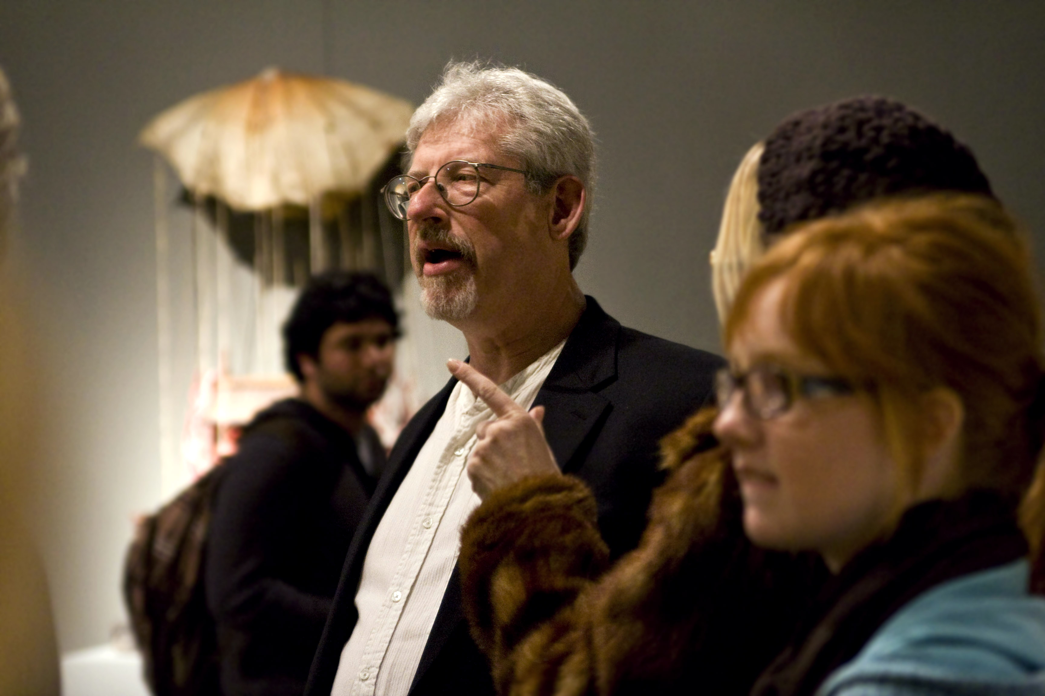 Barry Krammes, Biola art professor and former department chair, greats gallery attendees and reconnects with friends at the opening reception of his show, "Morality," Tuesday, Jan. 27. Photo by Kelsey Heng