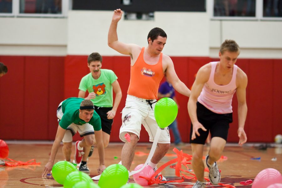 Josh Kaye, Johnny Vanderwell, Chris Mellon, and Chad Lucas race to pop all of their dorms balloons in one of the Nation Balls midway challenges. Photo by Mike Villa