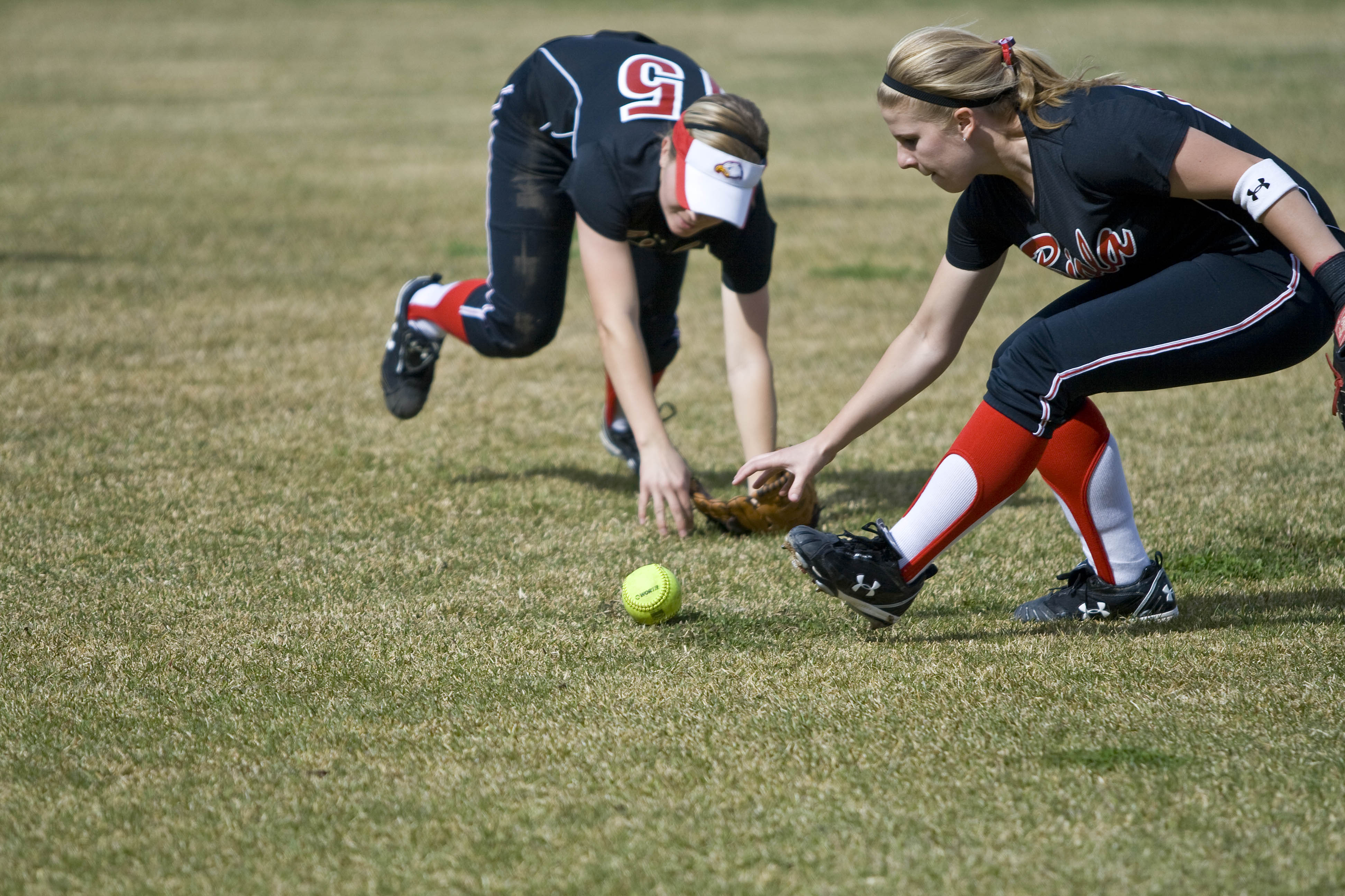 Juniors Jillian Albert and Krista Johnson reach for the ball in Tuesday's loss to Point Loma.  Photo by Bethany Cissel