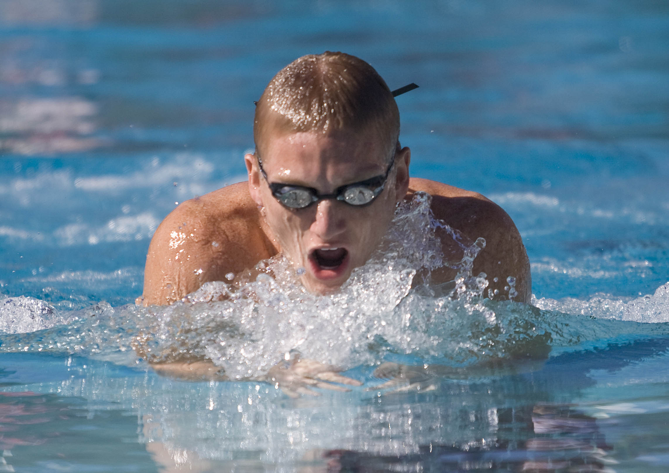 Sophomore Micah Perryman comes up for air during the 100-yard breaststroke in the alumni swim meet at Biola on Saturday, Jan. 31. The swim team completed in the Pacific Collegiate Swimming & Diving Conference Championships in Long Beach this weekend, where many qualified for the national championships that will take place in St. Peters, Miss. next week.  Photo by Kelsey Heng