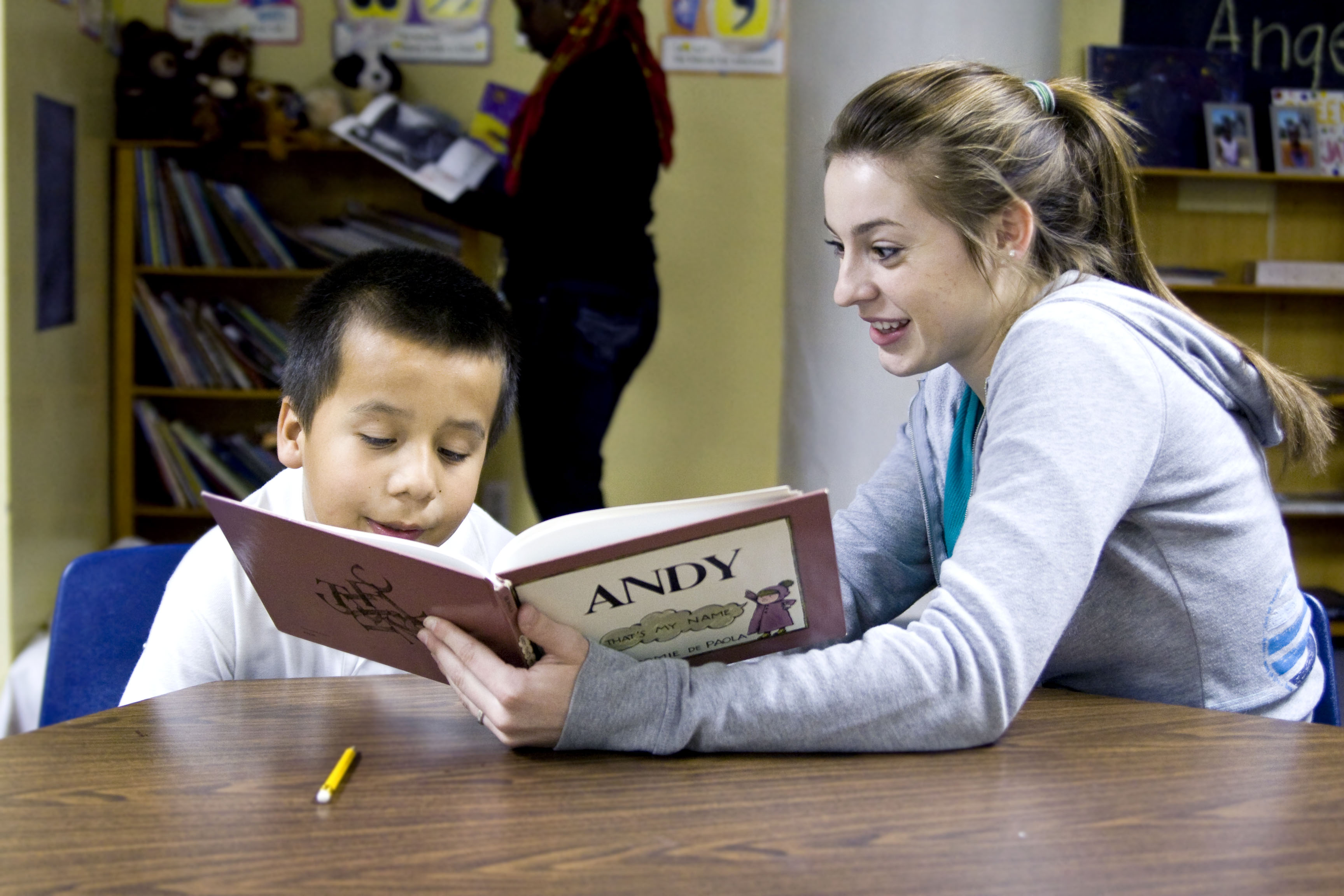 Biola student Haley Rocha uses the class time at the S.A.Y.  Yes! tutoring center to read a story to Richard, who is one of many elementary-aged children involved in the daily program. S.A.Y. stands for Saving America’s Youth. Photo by Kelsey Heng