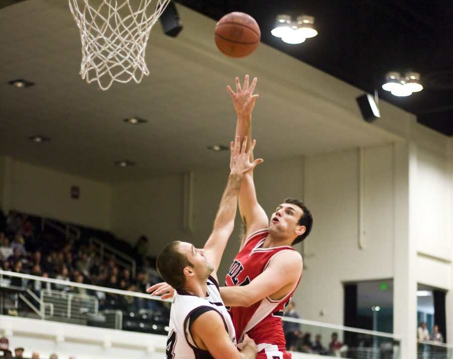 Junior Rocky Hampton shoots over an Azusa Pacific defender during the Eagles game on Tuesday, Feb. 10. Biola beat Azusa 76-54 with an audience of nearly 2.600 fans in APUs Felix Event Center.  Photo by Mike Villa
