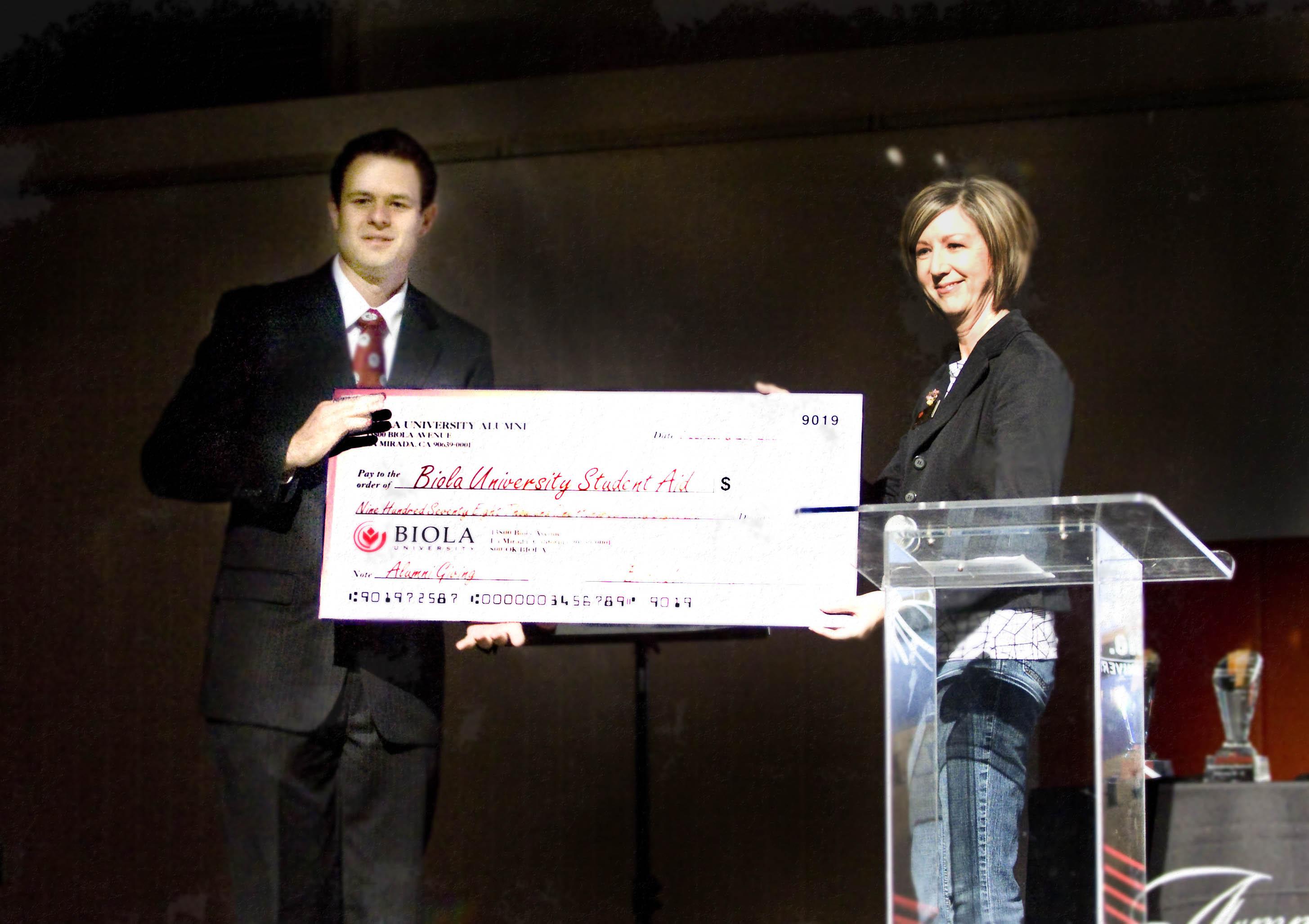 AS President Eric Weaver accepts a $978,168.89 check from Alumni giving for the student body during the Alumni Chapel on Friday, Feb. 20. The funds will be used for scholarships.  Photo by Kelsey Heng