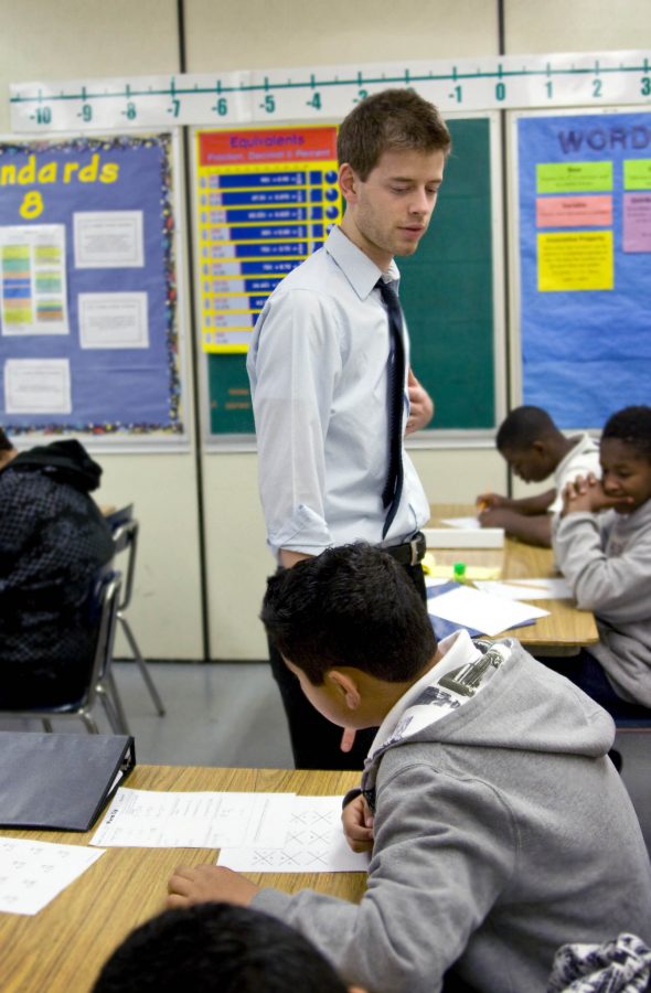 From one student to the next, Jeremy Mann, math teacher, helps each student with their specific questions on the in-class assignment.  Photo by Kelsey Heng