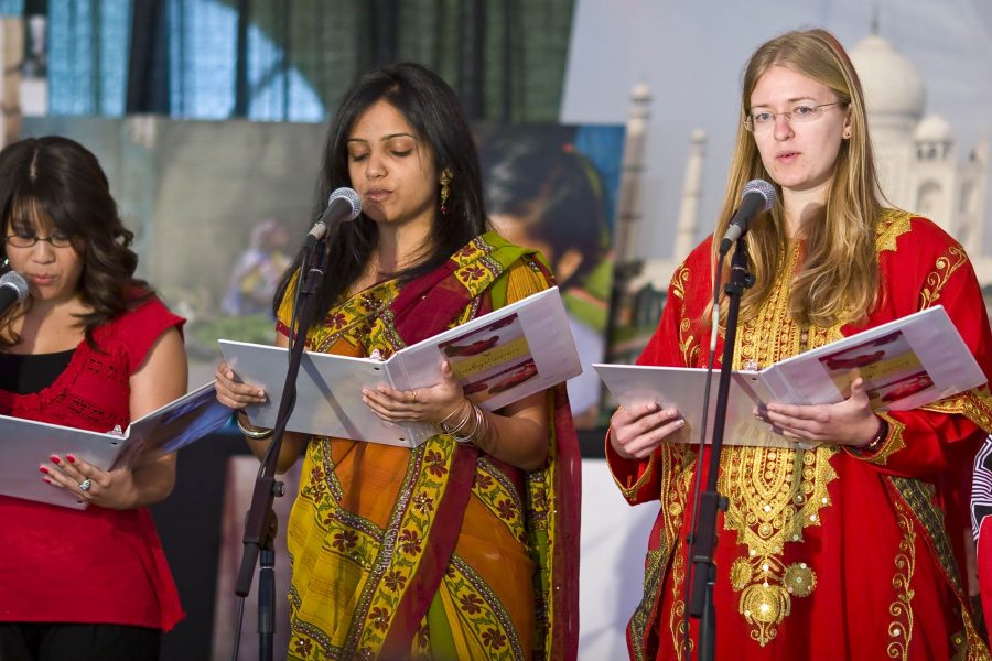 Current students Jennifer Chamale, Sheeba Musuku, and Elisabeth Lauesen perform a reader’s theater about the stories of women in their home countries during Biola’s second annual Ruby Slippers ceremony on Wednesday, March 11. 
 Photo by Christina Schantz