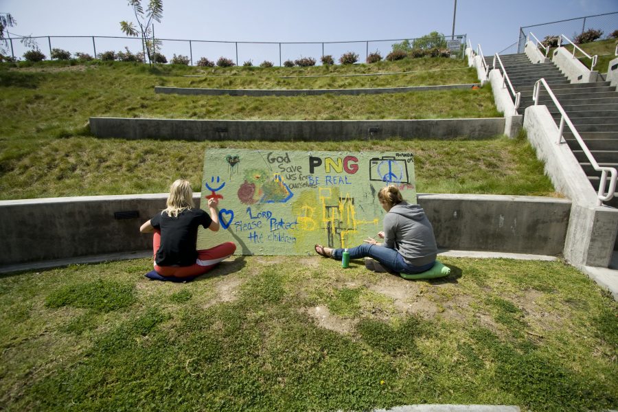 Two students work on an art piece outside at the Hope Amphitheater during a full day of Missions Conference activities.  Photo by Bethany Cissel