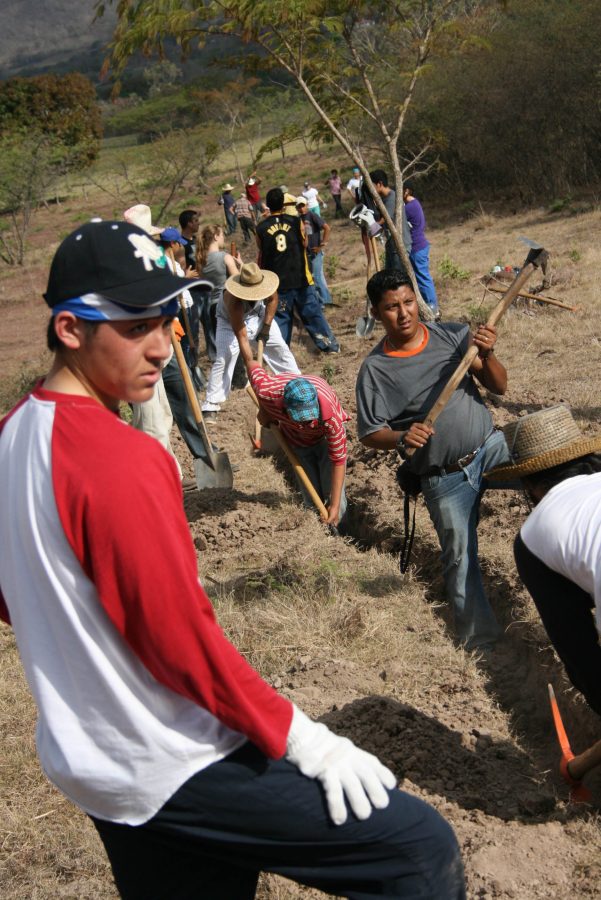 Freshman Ryan Hayashino scans the horizon as Biola students and Dos Quebardas community members together dig trenches that will bring water to the isolated village. Photo by Jocelyne Espinoza