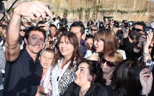 Actor Hugh Jackman, left, holds a camera to photograph himself and fans after he arrives for a promotion of his new movie X-Men Origins: Wolverineon Cockatoo Island in Sydney, Australia  April 8. (AP Photo/Aman Sharma)