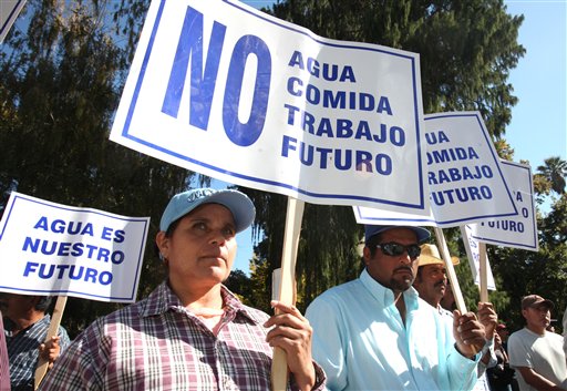 A protest sign is seen at a rally attended by an estimated 200 farm workers and members of a Hispanic water coalition calling on Gov. Arnold Schwarzenegger and state lawmakers to reach a solution to the states water problem at the Capitol in Sacramento., Calif., Friday, Oct. 9. (AP Photo/Rich Pedroncelli)