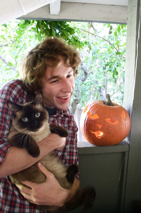Zach poses with the subject of his pumpkin art.