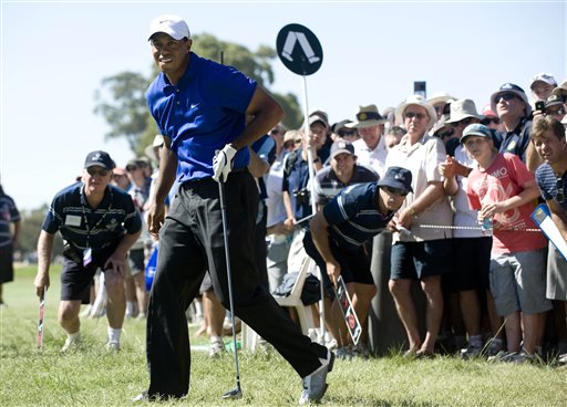 Tiger Woods from the United States watches after hitting an approach shot during the second round of the Australian Masters golf tournament at the Kingston Heath Golf Club in Melbourne, Australia. Woods was at 10-under 134. (AP Photo/Andrew Brownbill)