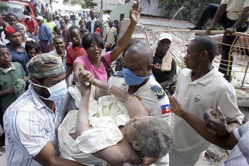 Gladys Loiuis Jeune is pulled alive from the rubble of her home in Port-au-Prince nearly 43 hours after Tuesdays earthquake, where she was greeted by her a cheering crowd Thursday, Jan. 14. (AP Photo/The Miami Herald, Patrick Farrell) NO MAGS; NO SALES; TV OUT
