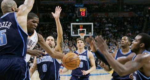 Oklahoma City Thunder forward Kevin Durant drives against Utah Jazz players before passing off during the second quarter of an NBA basketball game in Oklahoma City on March 14.