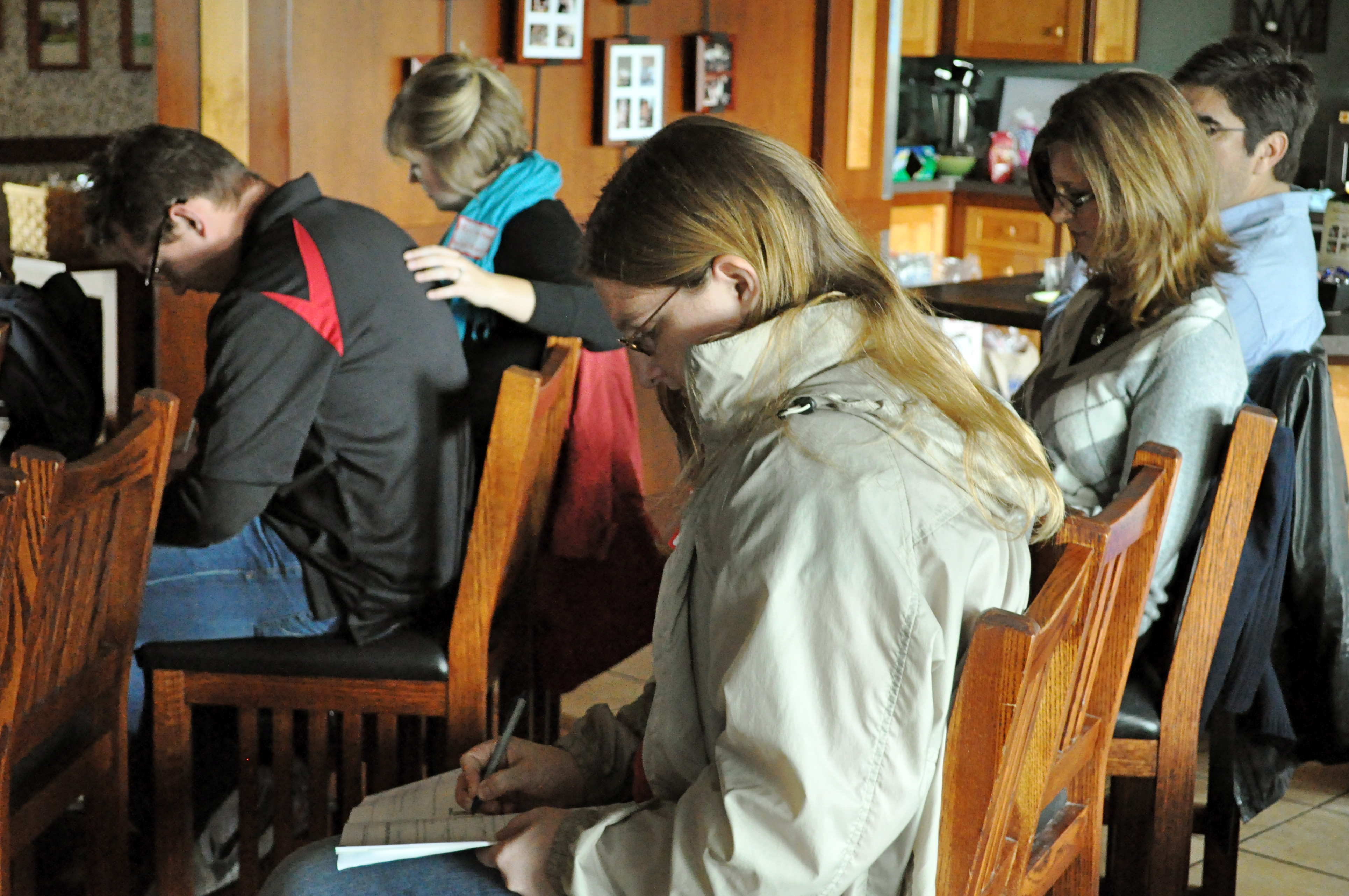 Ilsa Braun, 26, sits next to vice president of student development Chris Grace and his wife Alisa, taking notes on "The Power of Healthy Conflict" at a couples retreat Saturday morning. | Photo by Amy Ritter