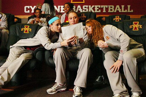Iowa States Shellie Mosman, Amanda Zimmerman and Chelsea Poppens, from left, look over a bracket after the broadcast of the NCAA womens basketball tournament selection show on March 15 in Ames, Iowa. | AP Photo/Ames Tribune, Ronnie Miller