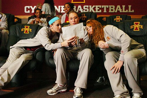 Iowa State's Shellie Mosman, Amanda Zimmerman and Chelsea Poppens, from left, look over a bracket after the broadcast of the NCAA women's basketball tournament selection show on March 15 in Ames, Iowa. | AP Photo/Ames Tribune, Ronnie Miller