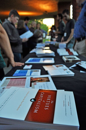 Attendees of the book release for The Virtues of Capitalism browse the information table on Thursday, May 9. In the book, authors Scott Rae and Austin Hill defend capitalism from a Christian worldview. | AMY RITTER / The Chimes