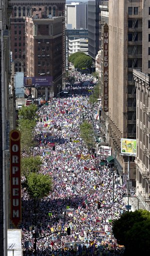 People make their way north on Broadway Street during a march and rally for federal immigration reform and a protest against Arizonas controversial immigration law in Los Angeles Saturday. | AP Photo / Jason Redmond)