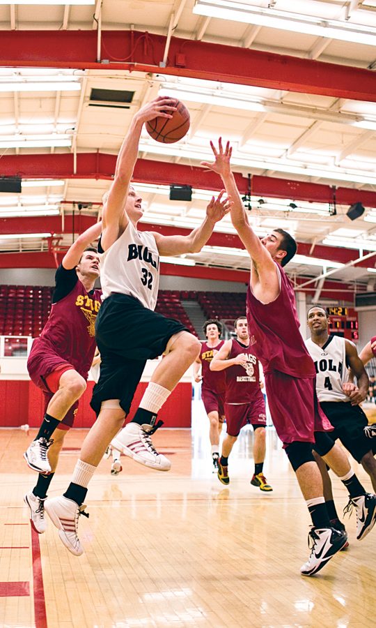 Freshman Kyle Bailey goes up for a layup against Claremont defenders. Biola begins regular season play on Saturday, Nov. 30 against California Maritime Academy. Photo by Mike Villa