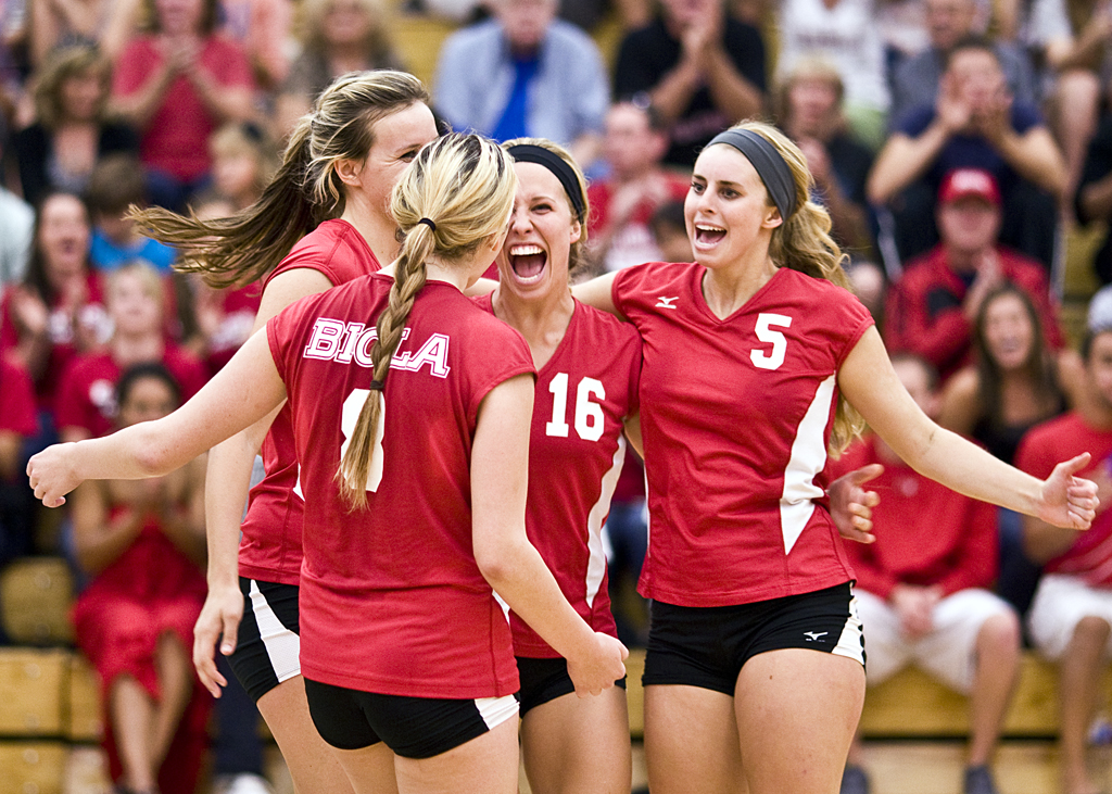 Seniors Abbie Wright and Amy Mosebar celebrate with teammates on the court during their 3-1 defeat of No. 14 Point Loma Nazerene. Wright had 31 assists and eight digs while Mosebar added six kills for the Eagles who have now won nine consecutive matches. BETHANY CISSEL/ The Chimes