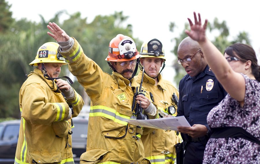 Captain Berry of the Los Angeles COunty Fire Department (left center) and John Ojeisekhoba, Biola Campus Safety Chief (right center) put together an evacuation plan at last Thursdays Great California ShakeOut. The citywide earthquake drill, set as a real life situation, was held on Biolas campus. Photo by Kelsey Heng