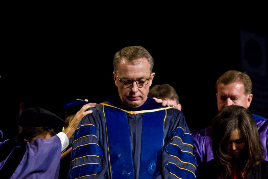 Faculty+and+students+pray+over+David+Nystrom+as+he+is+inaugurated+into+his+position+of+university+provost+at+the+inauguration+chapel+service+on+Friday+Nov.+5.+Biola+officially+welcomed+Nystrom+as+part+of+the+administration.+Photo+by+JOB+ANG%2FThe+Chimes
