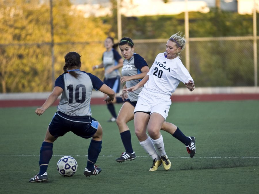 Sophomore Ashleigh Cooley challenges two Masters College forwards for the ball. Biola went on to defeat the Lancers 2-1 to earn a spot in Golden State Athletic Conference playoffs. Photo by BRAD MIERSMA/ The Chimes